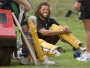 Cricket fans watch as player Andrew Symonds races behind them – let’s see who wins!