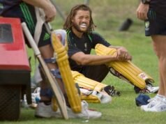Cricket fans watch as player Andrew Symonds races behind them – let’s see who wins!